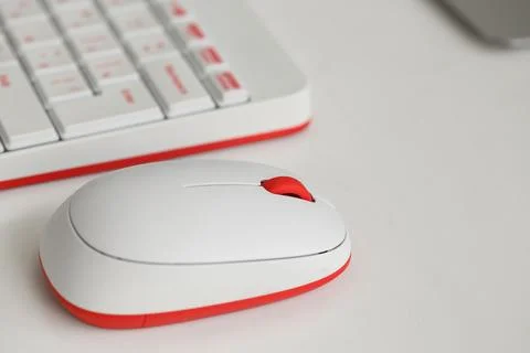 Modern computer mouse with keyboard on table in office Stock Photos