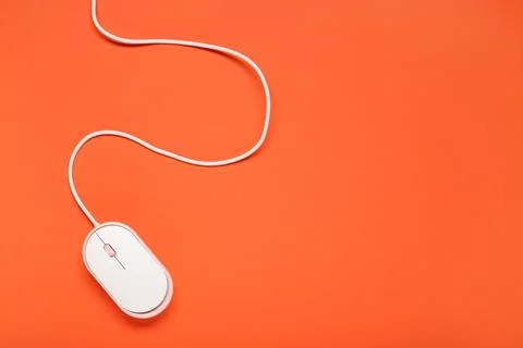 Modern computer mouse on orange background Stock Photos