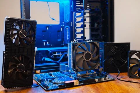Modern computer parts with PC case on background. Building personal gaming and Fotos de archivo