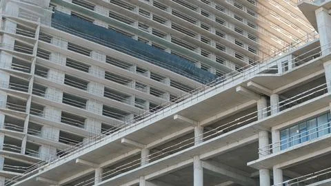 Modern concrete building under construction with scaffolding and framework Stock Photos