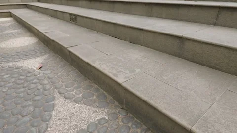 Modern concrete steps leading up with textured stone paving floor. Video stock 343415141