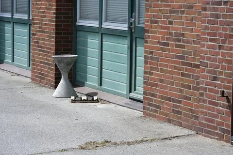 Modern Concrete Stool by Brick Building Stock Photos