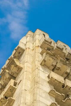 A modern concrete structure towers elegantly against the vibrant blue sky i.. Фото
