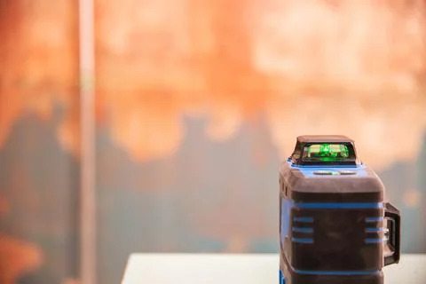 Modern construction laser level against the background of a wall with a concrete 写真素材