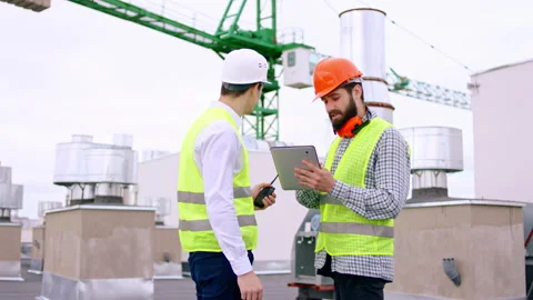 Modern construction site one builder and businessman on the roof top using Stock Footage 143154162