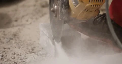Modern construction site worker is cutting concrete brick with an angle grinder Stock Footage 89932169