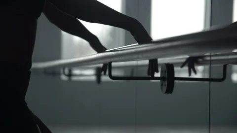 Modern contemporary dancer using dance studio hand rail to warm up Stock Footage 104269142