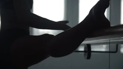 Modern contemporary dancer using dance studio hand rail to warm up 스톡 동영상 104269252