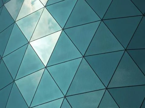  modern corporate building with angular patterned mirrored windows panes r... Stock Photos