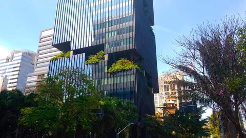 Modern corporate skyscraper featuring vertical gardens and glass exterior Stock Photos