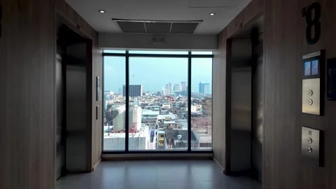 Modern corridor with elevators overlooking Samphanthawong District cityscape Stock Footage 320230099