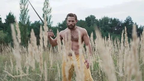 Modern cossack workouts with swords in the fields 4K Stock Footage 80529809