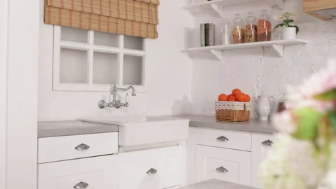 Modern, cottage-styled room dining room with appliances and charming flowers Stock Footage 235423160