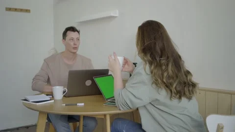 Modern couple working with laptops. Smart young couple discussing project at Stock Footage 139593558