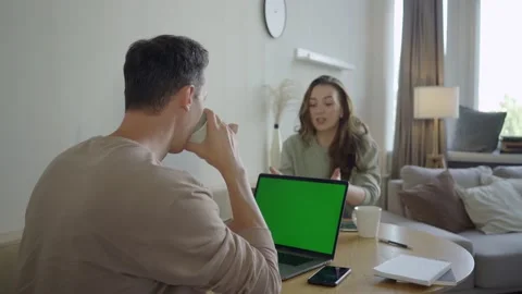 Modern couple working with laptops. Smart young couple discussing project at Stock Footage 139593576