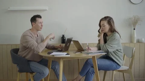 Modern couple working with laptops. Smart young couple discussing project at Video stock 141012614