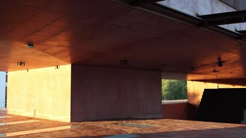 Modern covered terrace with dramatic warm sunset light and deep shadows Video stock 345029054