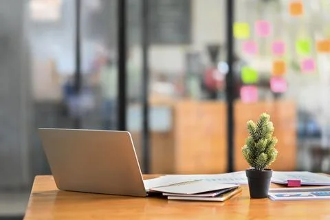 Modern creative office interior with laptop computer, documents and various Stock Photos