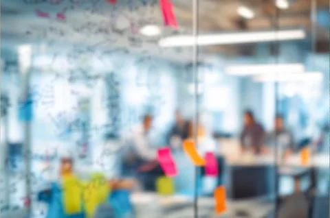 Modern creative office space viewed through glass partition decorated with .. Stock Photos