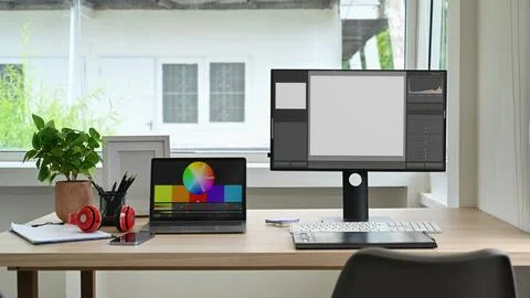 Modern creative office studio interior with laptop, blank screen computer 스톡 사진