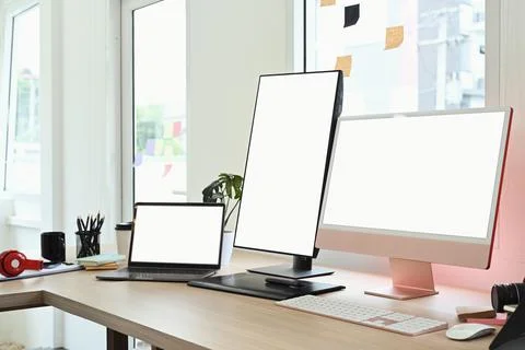 Modern creative office studio interior with laptop, blank screen computer and Stock Photos