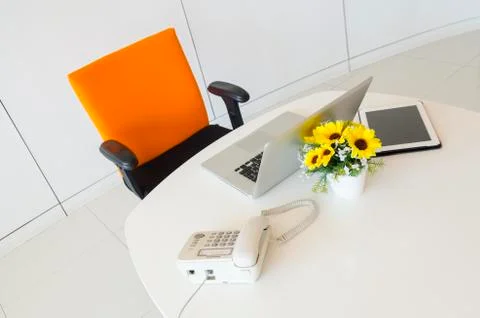 Modern creative workspace with computer and orange chair. The office of a cre Stock Photos