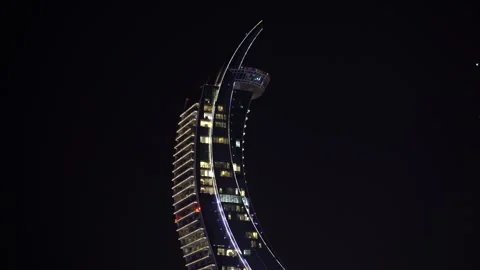 Modern Crescent-Shaped Skyscraper at Night in Lusail Stock-Footage 336047574