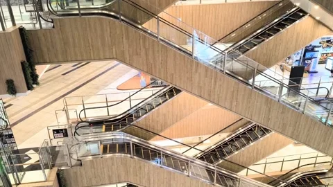 Modern crisscross escalators inside a Jakarta shopping mall Stock Footage 337929598