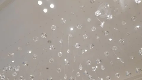 Modern crystal pendant light installation on luxury ceiling slow pan Stock Footage 337513946