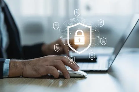 Modern cybersecurity concept showcasing hands using laptop with digital pad.. Stockfoto's