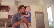 Modern Dad Holding And Kissing Infant Daughter On Cheek Stock Footage
