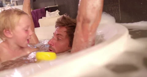 Modern Dad Plays with Son in Bubble Bath at Home Stock Footage 61501800