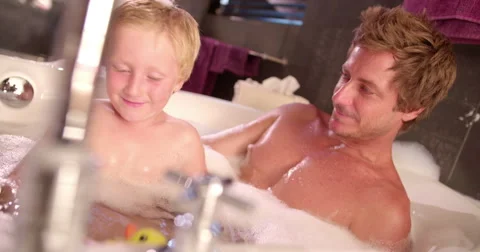 Modern Dad Plays with Son in Bubble Bath at Home Stock Footage 61501809