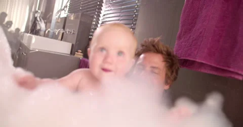 Modern Dad Taking Bubble Bath with Infant Daughter Stock Footage 61500029
