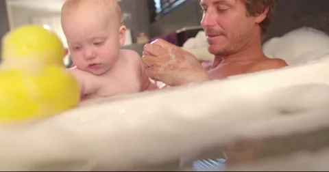 Modern Dad Taking Bubble Bath with Infant Daughter Stock Footage 61501662
