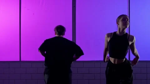 Modern Dance Performance Against a Purple Background Wall 스톡 동영상 334568138