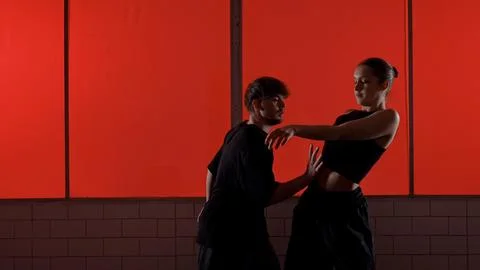 Modern Dance Performance Against a Red Background Wall Stock Photos