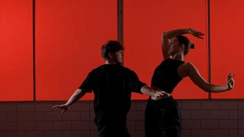 Modern Dance Performance Against a Red Background Wall Stock Photos