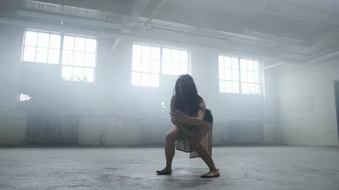 Modern dancer dances in industrial warehouse filled with fog 스톡 동영상 104473526