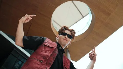 Modern dancer posing at camera with confident with low angle camera. Endeavor. Photos