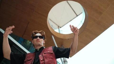 Modern dancer posing at camera with confident with low angle camera. Endeavor. Photos