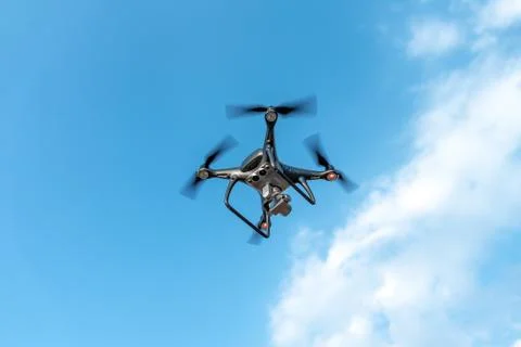 Modern dark drone in the sky. Stock Photos