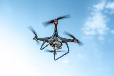 Modern dark drone in the sky. Stock Photos