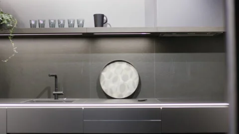 Modern dark gray kitchen interior with minimalist faucet and shelf lighting Video stock 155208526