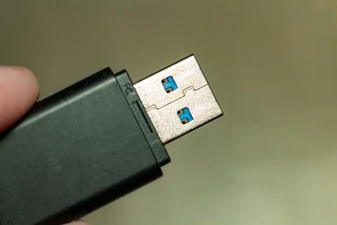A modern dark green usb flash drive connector for data storage and transfer Stock Photos