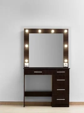 Modern dark makeup dressing table with mirror and backlight against a white.. Stock Photos