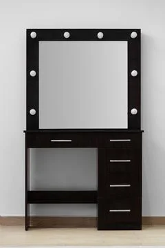 Modern dark makeup dressing table with mirror and backlight against a white.. Stock Photos