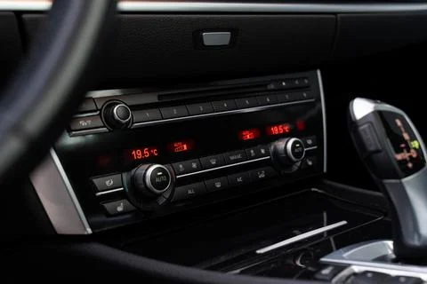 Modern dashboard with various buttons and screen showing temperature inside Stock Photos