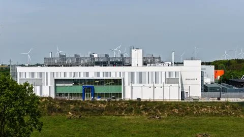 Modern Data Center Building with Wind Turbines in Green Landscape Fotos Stock