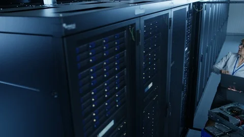 In the Modern Data Center: Engineer and IT Specialist Work with Server Racks Stockbeeldmateriaal 101179320